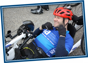 Gary on his hand cycle taking part on a previous overseas cycle ride in support of SIA