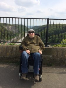 mike wheelchair user smiling in sunglasses on holiday