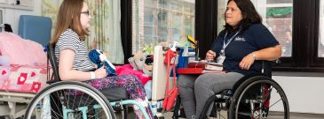 spinal cord injured patient talking to spinal injury association advisor