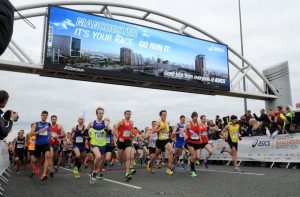Runners crossing start line at Manchester Marathon