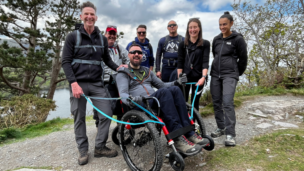 a smiling Martin Hibbert and support team in training 