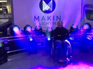 jonathan makin lightin in front of signage