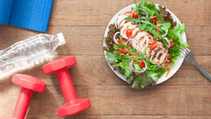 exercise nutrition banner with weights and salad bowl
