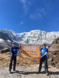 marcus monty annapurna base camp trek holding SIA flag