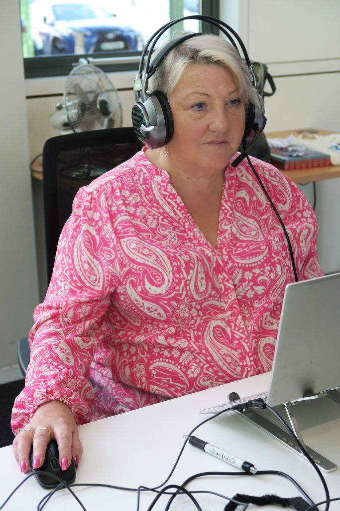 Teresa Skinner SIA support line with headphones on