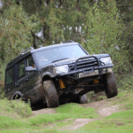 Range Rover 4x4 vehicle going over a hill