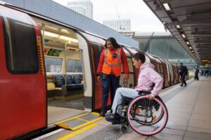 Wheelchair user boarding an underground train using a ramp