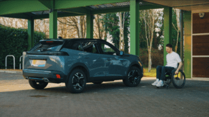 Screenshot from driving video. Joe and car at SIA House