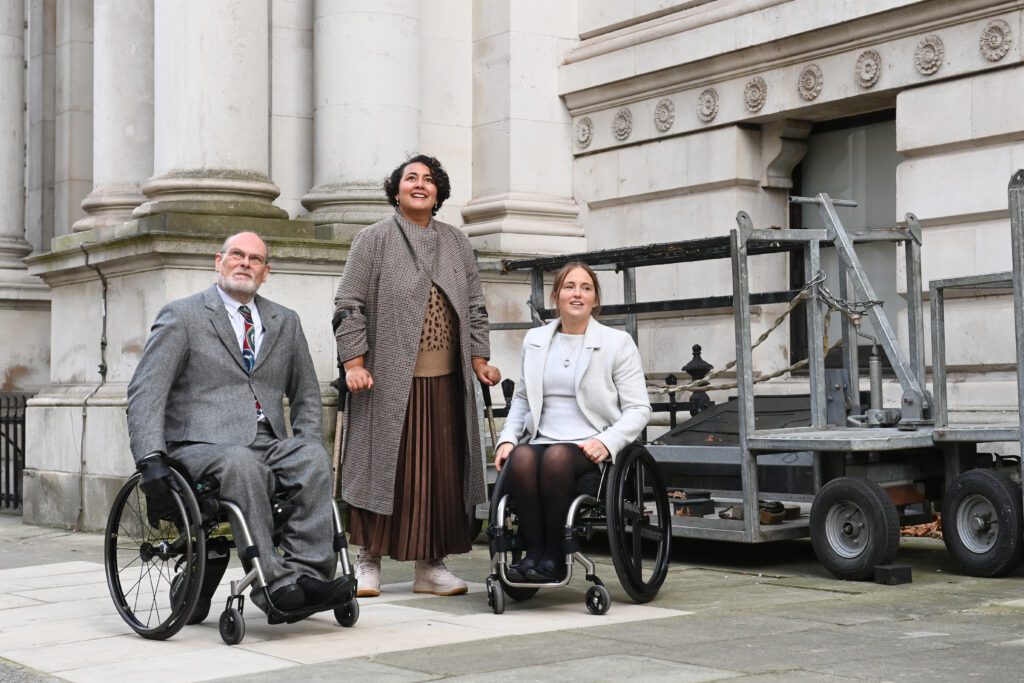 SIA at 10 Downing Street London. Showing two SIA ambassadors and our director looking up towards the street