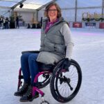 Female wheelchair user using Invictus equipment on ice rink