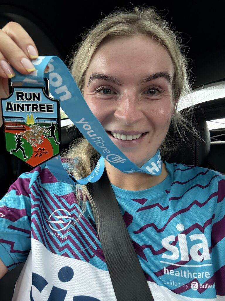 Katie Nield Forward Story with medal and smiling