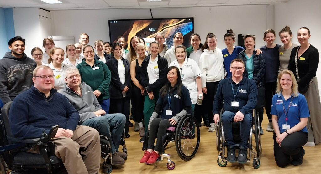 Two members of our support network team with hospital staff at an in service training event